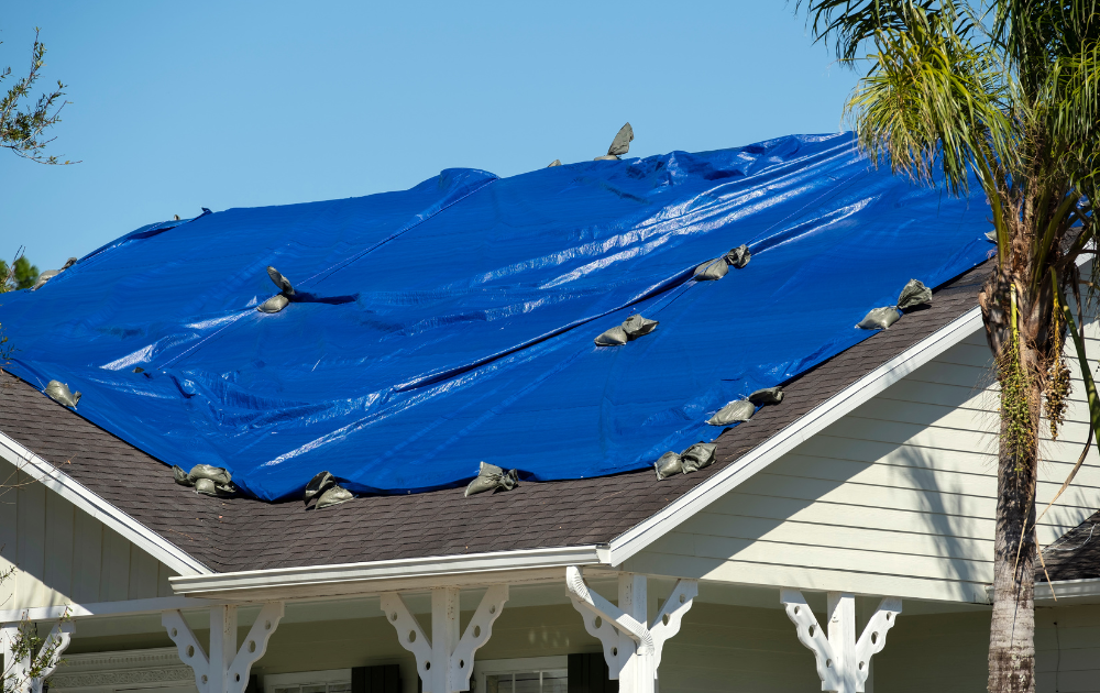 An emergency tarp is placed on the roof to cover it and stopping further water leakage inside the home