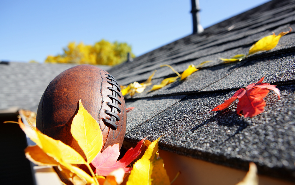 A tradesman is removing debris from the dirty roof which as part of the cleaning process