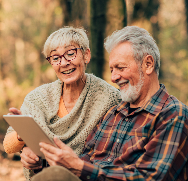 An old happy couple viewing on the tab the best family services they got from HolyMess Repairs