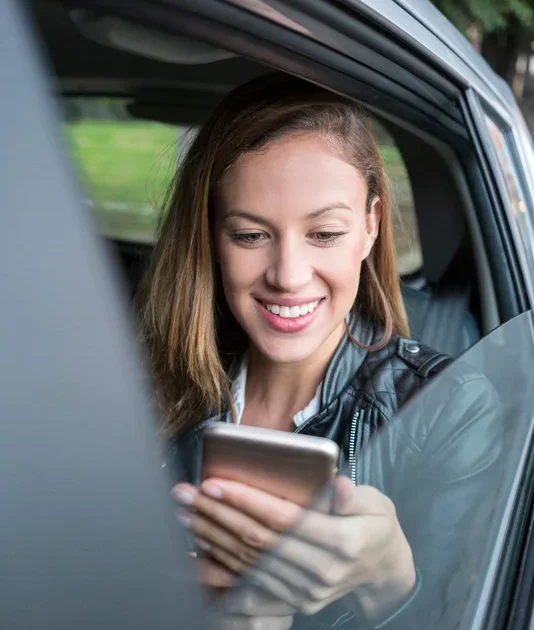 Lady looking at phone and smiling