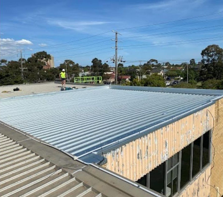 rusted roof replaced with cartoon roofer by the left