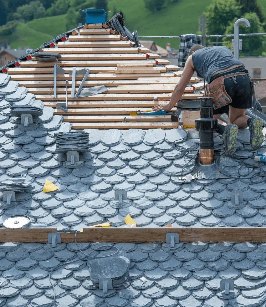 Slate roof specialist at work installing roof