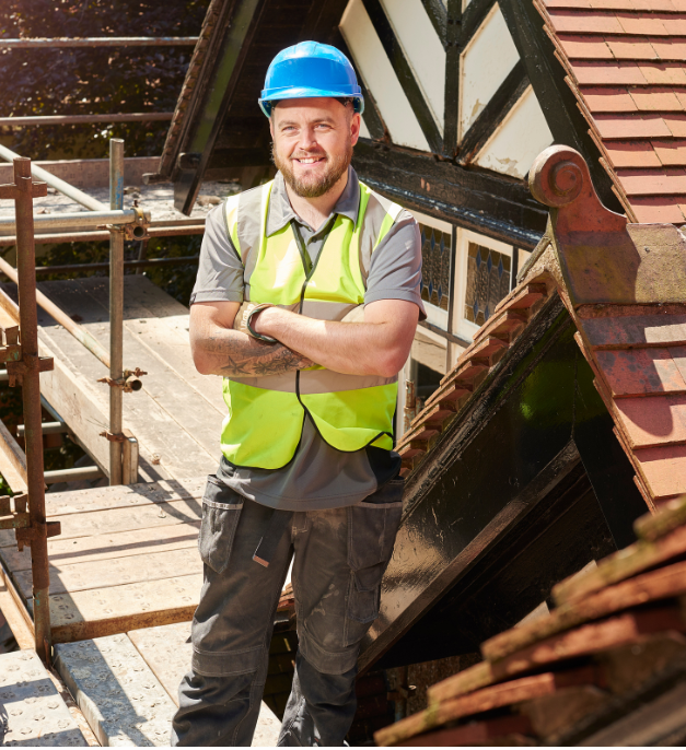 roofer on a roof smiling