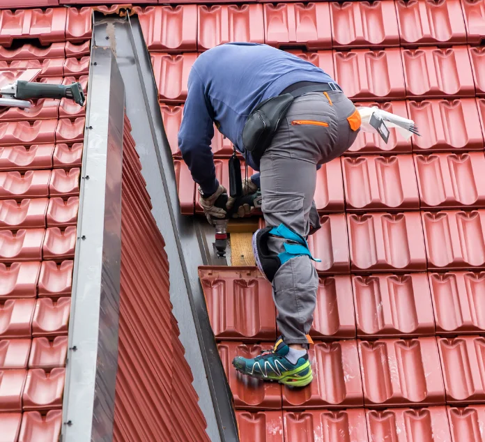 man on roof fixing roof leak in bundoora